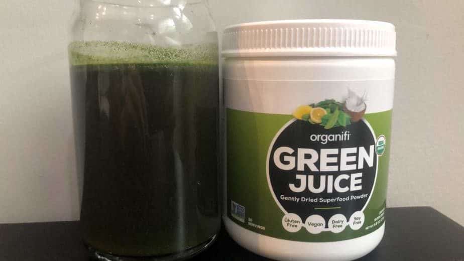 Organifi green juice drink next to the jar