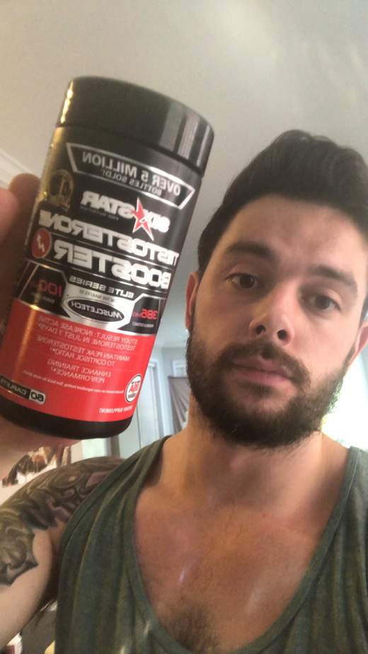 Me holding the six star testosterone booster bottle